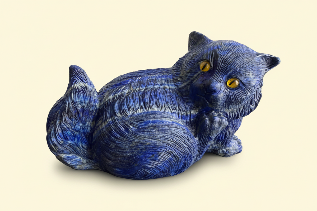 King Lapis blue lapis lazuli cat sculpture three-quarter view on a warm ivory background